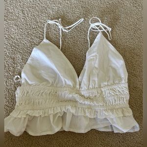 White tie tanktop with ruffles. Size Medium.